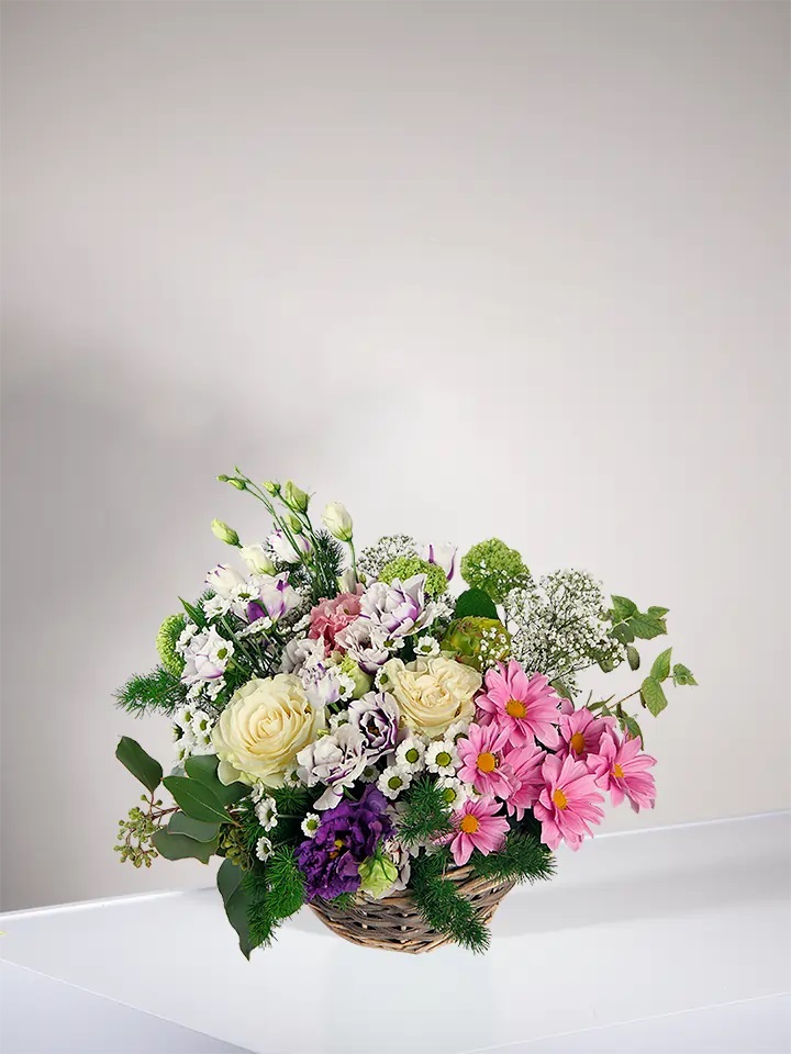 Basket of white, pink and purple flowers