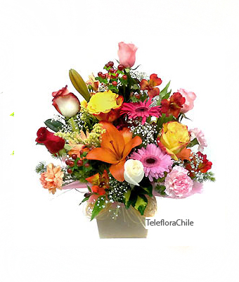 Mixed flowers arrangement in a container. (Only Santiago)